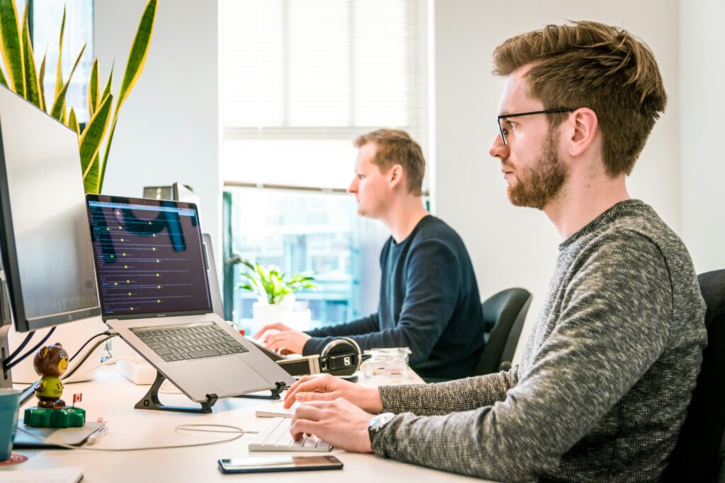 two guys working on computers in their start up business